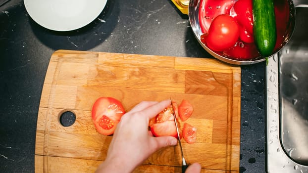 woman housewife in the kitchen. woman cuts vegetables, cooking, knife on a cutting board. Hands cooks close up