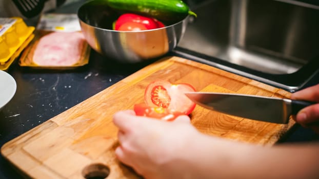 woman housewife in the kitchen. woman cuts vegetables, cooking, knife on a cutting board. Hands cooks close up