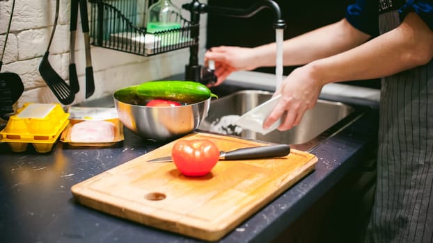 woman housewife in the kitchen. woman cuts vegetables, cooking, knife on a cutting board. Hands cooks close up