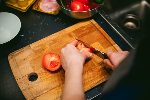 woman housewife in the kitchen. woman cuts vegetables, cooking, knife on a cutting board. Hands cooks close up