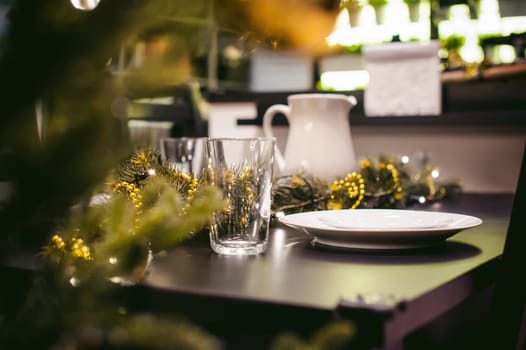 close-up objects at the dinner table. to decorate the table in the New Year's Eve, there are plates, jug and glass