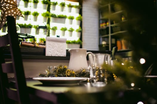close-up objects at the dinner table. to decorate the table in the New Year's Eve, there are plates, jug and glass