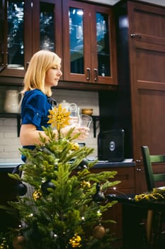 woman housewife setting the table. young blonde in a dress and apron, served in a dining table, puts the dishes, doing the work in the kitchen