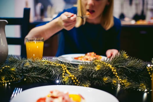 woman eating homemade food, of own preparation fried egg. breakfast for two persons, at home in the kitchen at the dining table