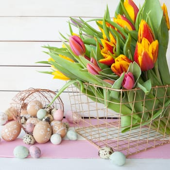Painted eggs and fresh tulips for Easter