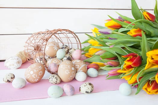 Painted eggs and fresh tulips for Easter