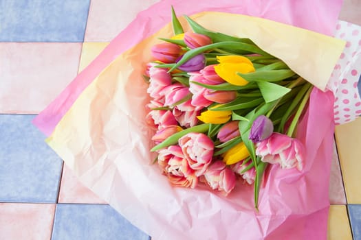 Fresh colorful tulips in tissue paper