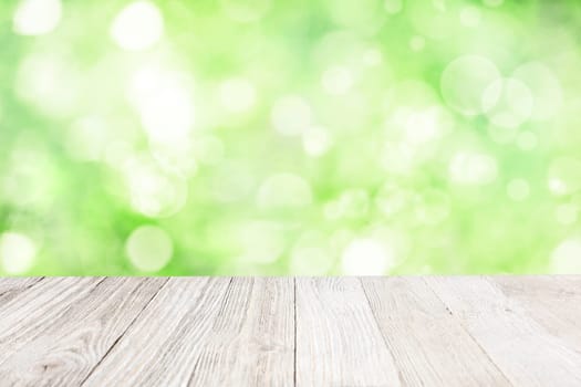 Wooden deck with blurred garden background