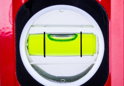 Spirit level bubble close up showing perfectly level alignment. Workman tool for finding the horizontal