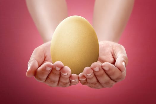Image of people hand hold plain egg. Easter concept, you can design your own pattern at the egg