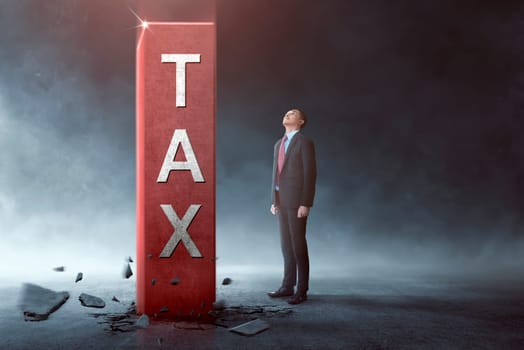 Young asian businessman looking at high tax block come out from the ground