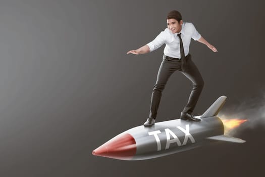 Young asian businessman on a rocket with Tax sign over gray background. Taxation concept