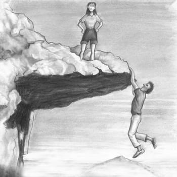 One female stands on an outcropping that a man dangles from the bottom edge of. Woman looks from a cliff top while a man hangs from it with his hands.