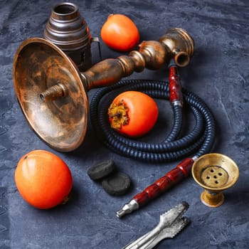 Smoking hookah with the tobacco flavor with the taste of ripe persimmons