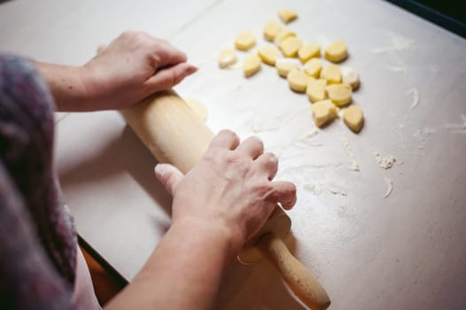 hand modeling dumplings at home in the kitchen. pelmeni lay on a baking sheet