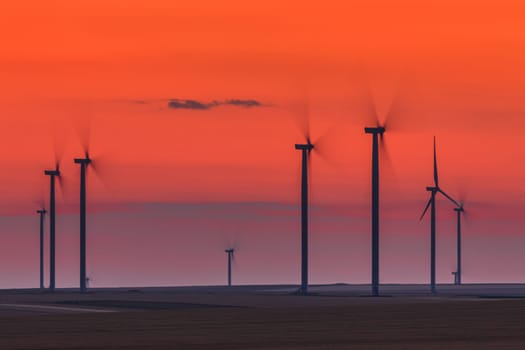 wind power turbines on a hill in sunset. Dobrogea Romania