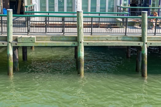 New York, NY, USA - June 06, 2015: Pier A Harbor House with restaurant situated on the Hudson River at Battery Park, Lower Manhattan. Modern skyscrapers in the background. Blue sky.