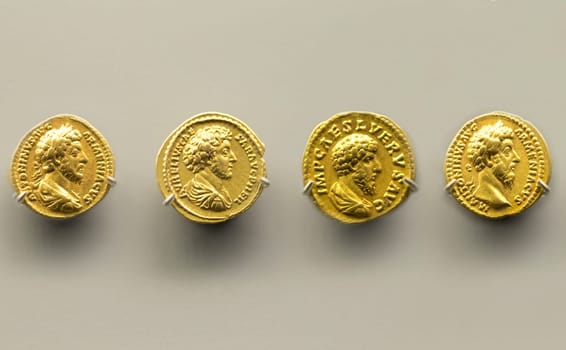 Merida, Spain - December 20th, 2017: Four golden coins of Marcus Aurelius Emperor at National Museum of Roman Art in Merida, Spain