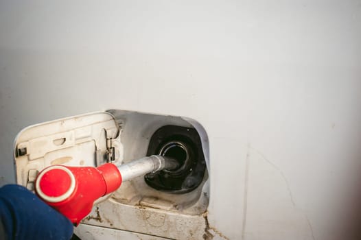 refueling nozzle is inserted in the tank car at a gas station