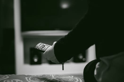 girl in a home environment, holding a TV remote, switching channels