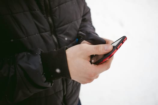 Man hand with the phone in his hand close-up