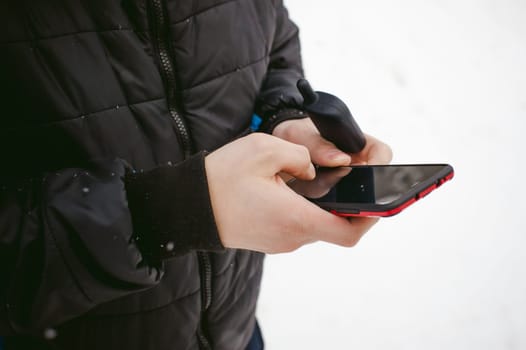 Man hand with the phone in his hand close-up