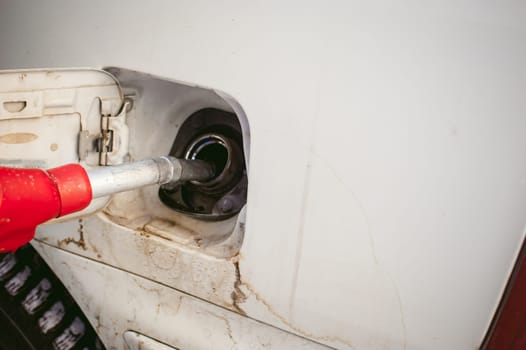 refueling nozzle is inserted in the tank car at a gas station