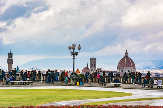 Florence, Italy, march 28, 2016: tourists relaxing and enjoying the panoramic view of Florence from the terrace of Piazzale Michelangelo