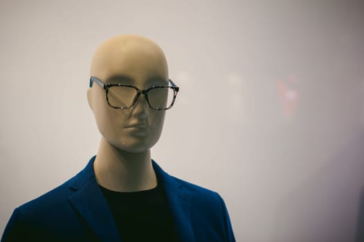 dummy on a shop window. Faceless man's glasses