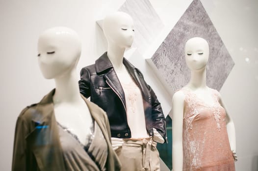 dummy on a shop window. Faceless women in fashionable clothes