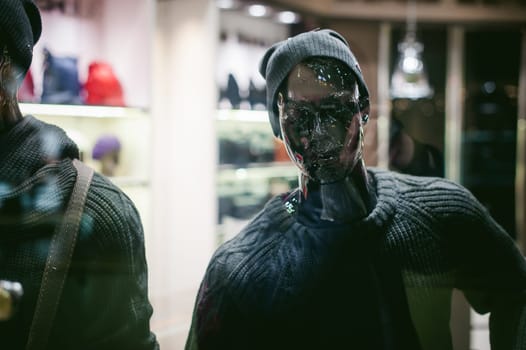 dummy on a shop window. Faceless black man in hat