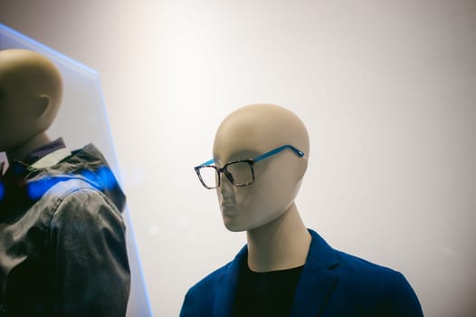 dummy on a shop window. Faceless man's glasses