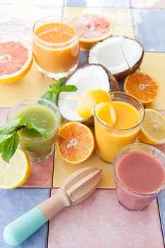 Various colorful smoothies and fresh fruits