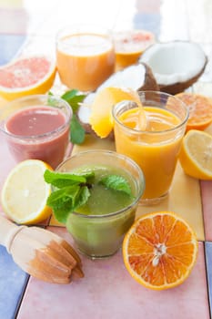 Various colorful smoothies and fresh fruits