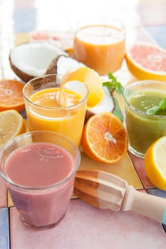 Various colorful smoothies and fresh fruits
