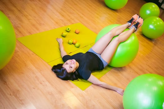 Fitness girl with fruits, lifestyle in losing weight and diets, proper nutrition, exercise