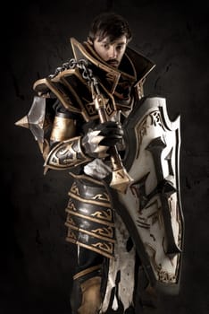 Young man cosplaying with fantasy knight costume