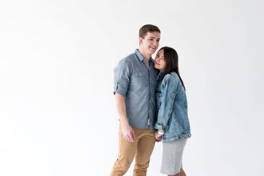 young couple, man and woman in trendy jeans clothes, studio shot on white background