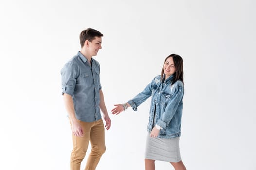 young couple, man and woman in trendy jeans clothes, studio shot on white background