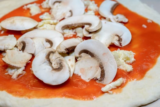 Tipical Italian Pizza with mushrooms waiting to be cooked in a wood steam