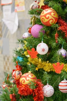 portion of a Christmas tree with colorful decorations