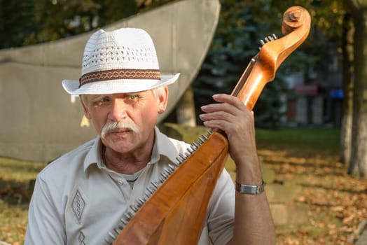Kharkiv, Ukraine - August 27, 2014: An ukrainian man playing an instrument in Kharkiv, Ukraine.