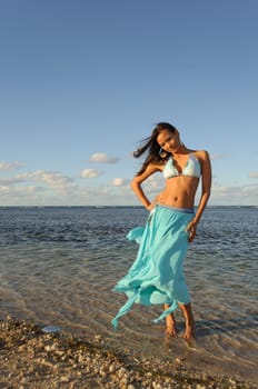 Beautiful and sexy girl posing at the beach in dominican republic dressing bikini and a turquoise skirt