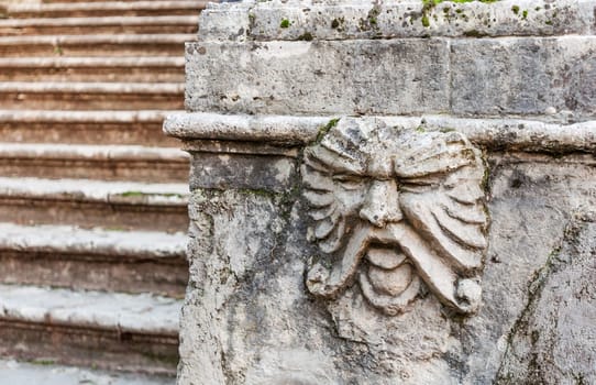 sculpture of a face in marble wall