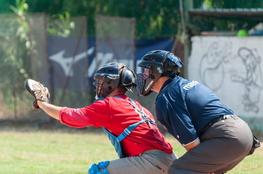 Rome, Italy - July 11, 2010: A catcher and the referee during an inning of a game in a local cup
