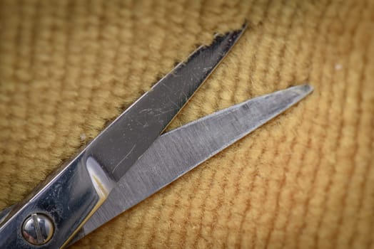 Scissor tips on a brown texile background