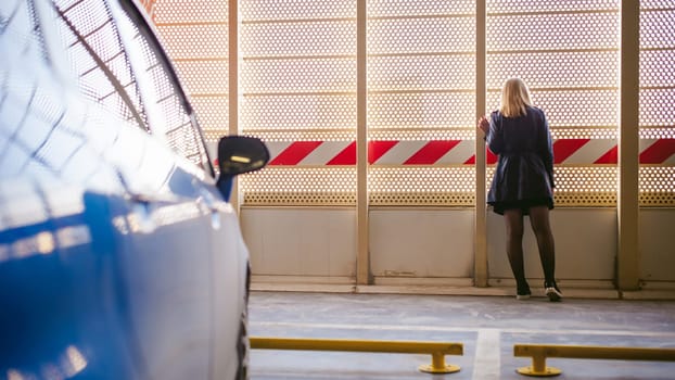 Woman in parking lot on blue car background