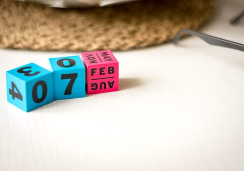 modern perpetual calendar composed of colored cubes and set at the date of February 7th