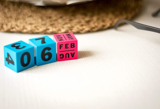 modern perpetual calendar composed of colored cubes and set at the date of February 6th