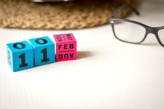 modern perpetual calendar composed of colored cubes and set at the date of February 11th